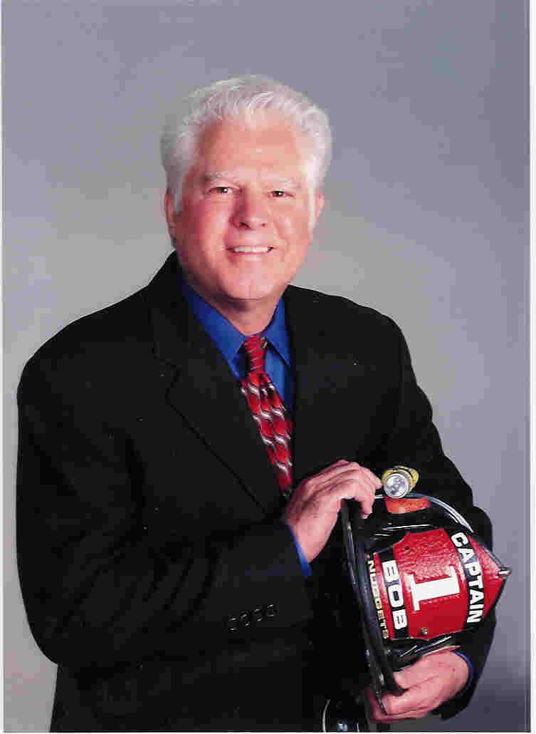 Fire Captain Bob holding a firefighter hat.