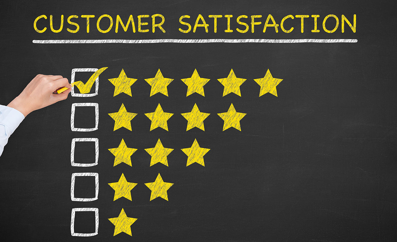 Customer satisfaction rating on chalkboard. Five stars checked.
